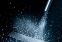 http://A%20spray%20of%20small%20shot%20is%20rebounding%20off%20a%20piece%20of%20metal%20after%20being%20fired%20from%20a%20nozzle.