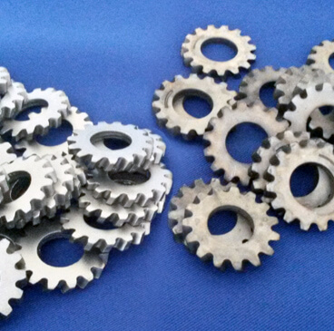 http://Two%20piles%20of%20small%20gears,%20showing%20the%20difference%20between%20peened%20and%20unfinished%20parts.