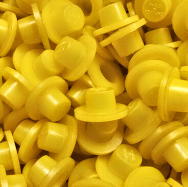 http://Pile%20of%20yellow%20plastic%20caps%20that%20are%20used%20to%20mask%20parts%20during%20various%20finishing%20processes.